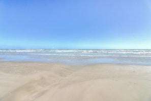 Enjoy a serene beach experience with ample space for walking or relaxation.