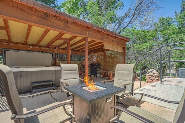 Evenings come alive with the fire table glow, a bubbling hot tub, and a grill ready for family meals.