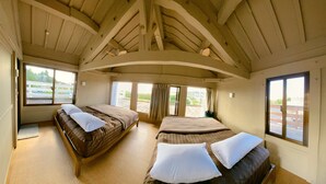 A room with two beds, a wooden ceiling, and large windows. - Villa SERENO MOTOBU  (Motobu)