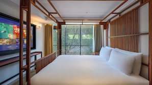A hotel room with a large bed, wooden headboard, and a TV on the left wall. - Hutong Cultural Heritage Hotel Beijing (Beijing)