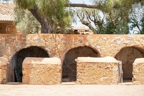 Explore ancient passageways through three arched openings supported by stone columns.