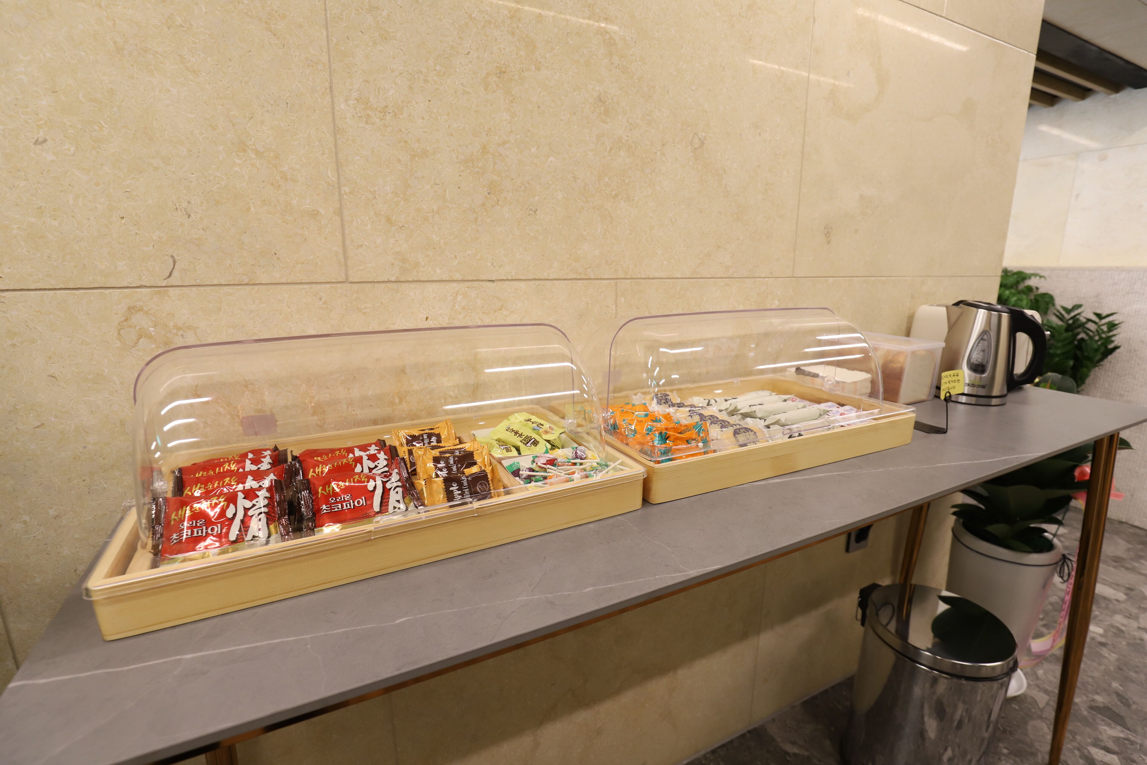 A buffet counter with various food items in clear containers.