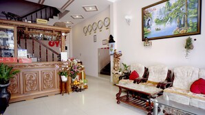 A well-furnished living room with a sofa set, a coffee table, and a staircase leading to another level.