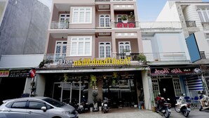 A multi-story building with a sign reading "OYO" on the top floor.