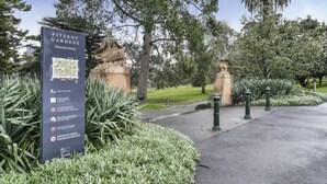 A sign for Fitzroy Gardens on Clarendon Street with a map and parking information.