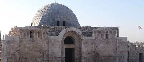 A historical building with a large dome and an arched entrance.
