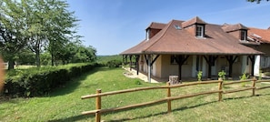 A two-story house with a wooden roof and a covered porch.