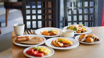 A breakfast table with various dishes including toast, eggs, and pastries.