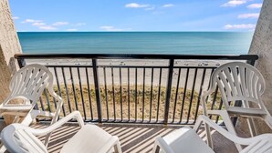 A balcony with a view of the beach and ocean. - Stunning Views 2BR Oceanfront, Beach Cove & Pools (North Myrtle Beach)