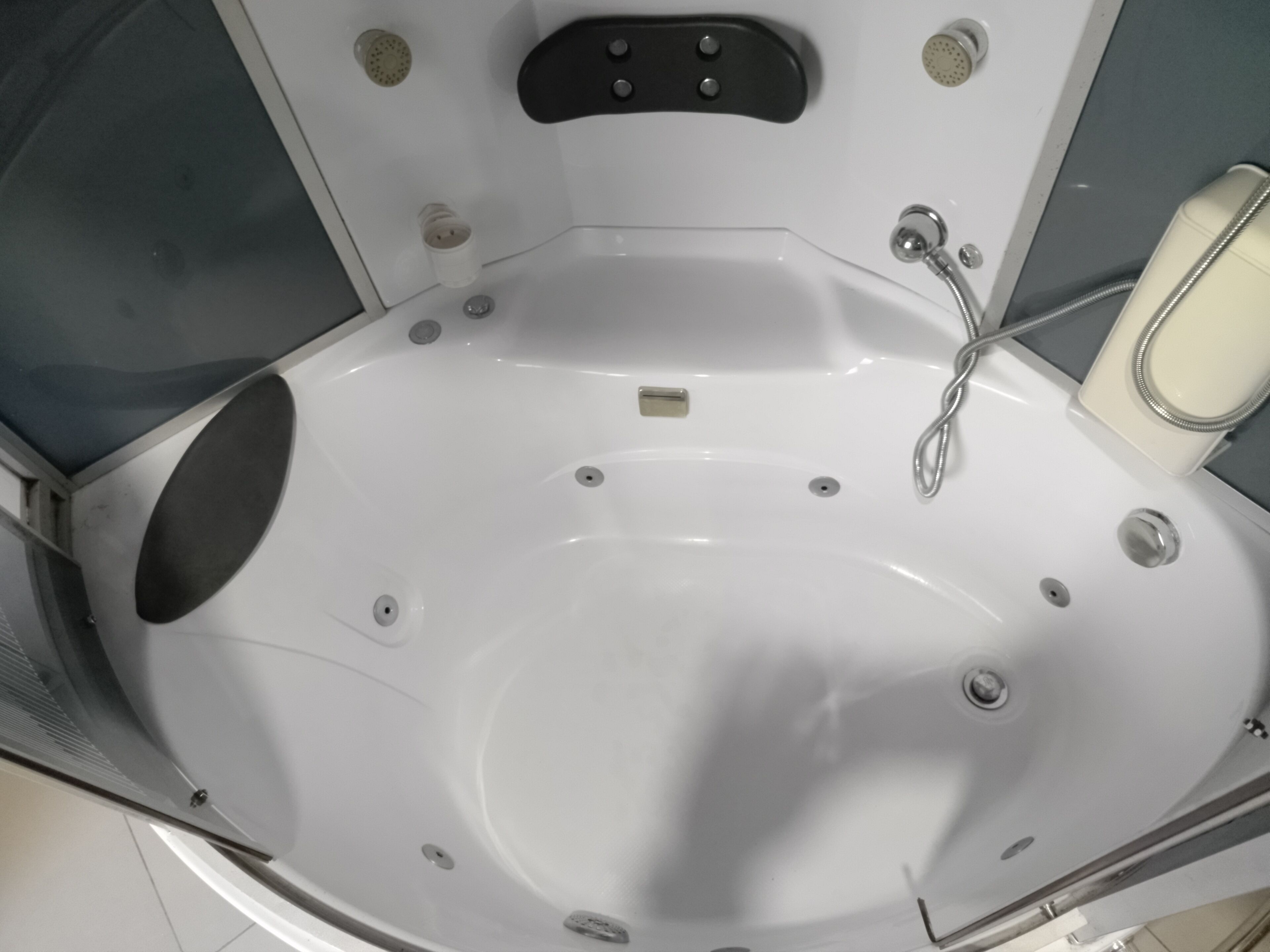 A modern bathroom with a large bathtub, a shower area, and a toilet.