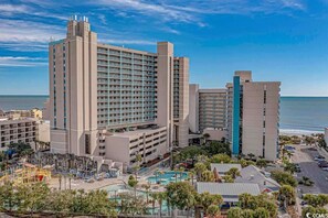 A large hotel with multiple floors and a pool area. - 3BR in Sand Dunes Resort Ocean View - Great Views (Myrtle Beach)