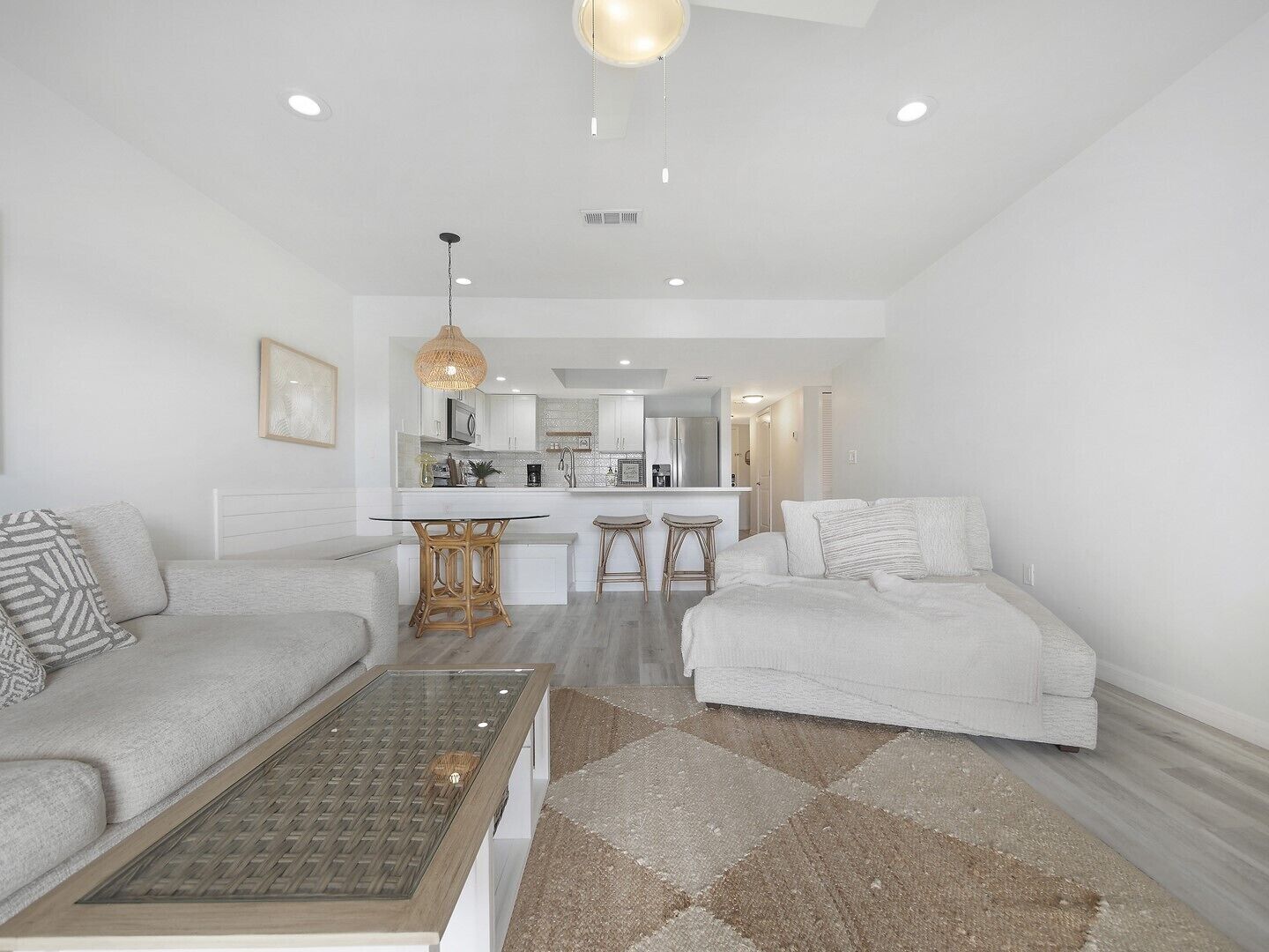 A modern living room with a sofa, a coffee table, and a rug.