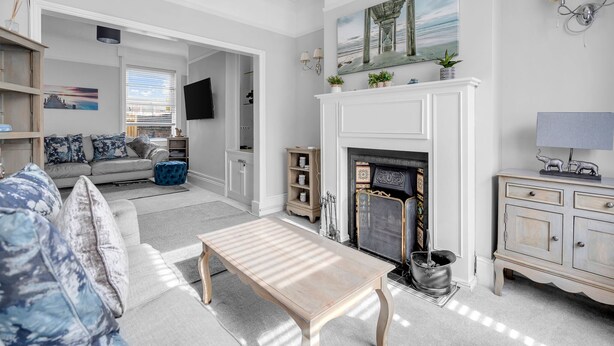 A living room with a fireplace, a sofa, a coffee table, and a television. - Super Comfortable & High Quality (Cleethorpes)