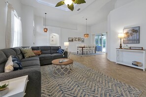 Relax in this inviting living space with a sofa, coffee table, and dining area.