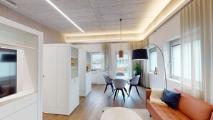 A modern apartment with a kitchen, dining area, and living room. - LivingTown Lofts Zurich (Zürich)