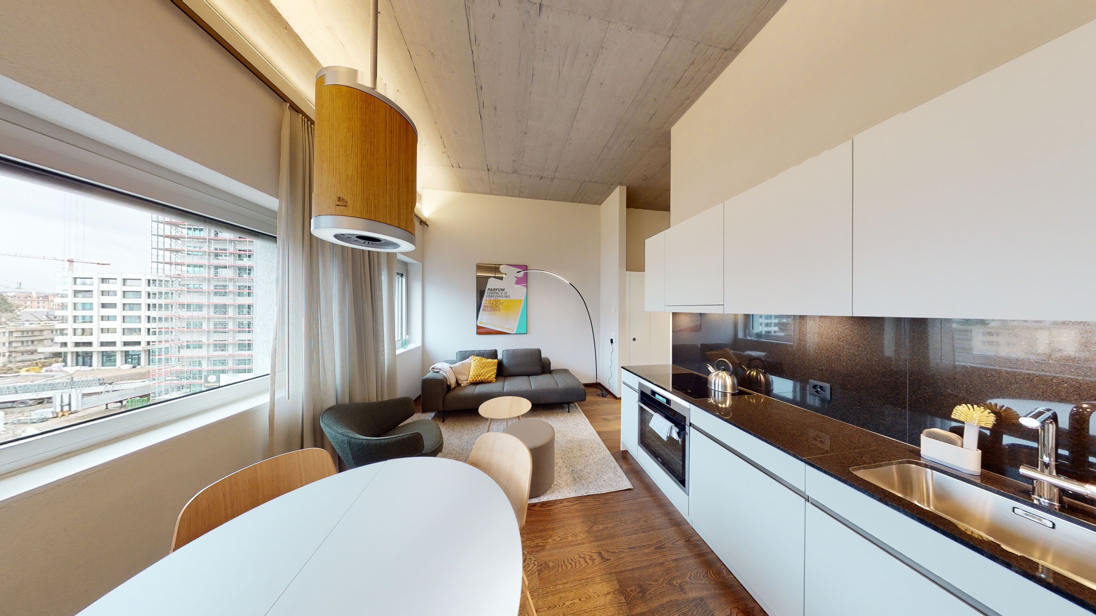A modern apartment with a kitchen, dining area, and living space.