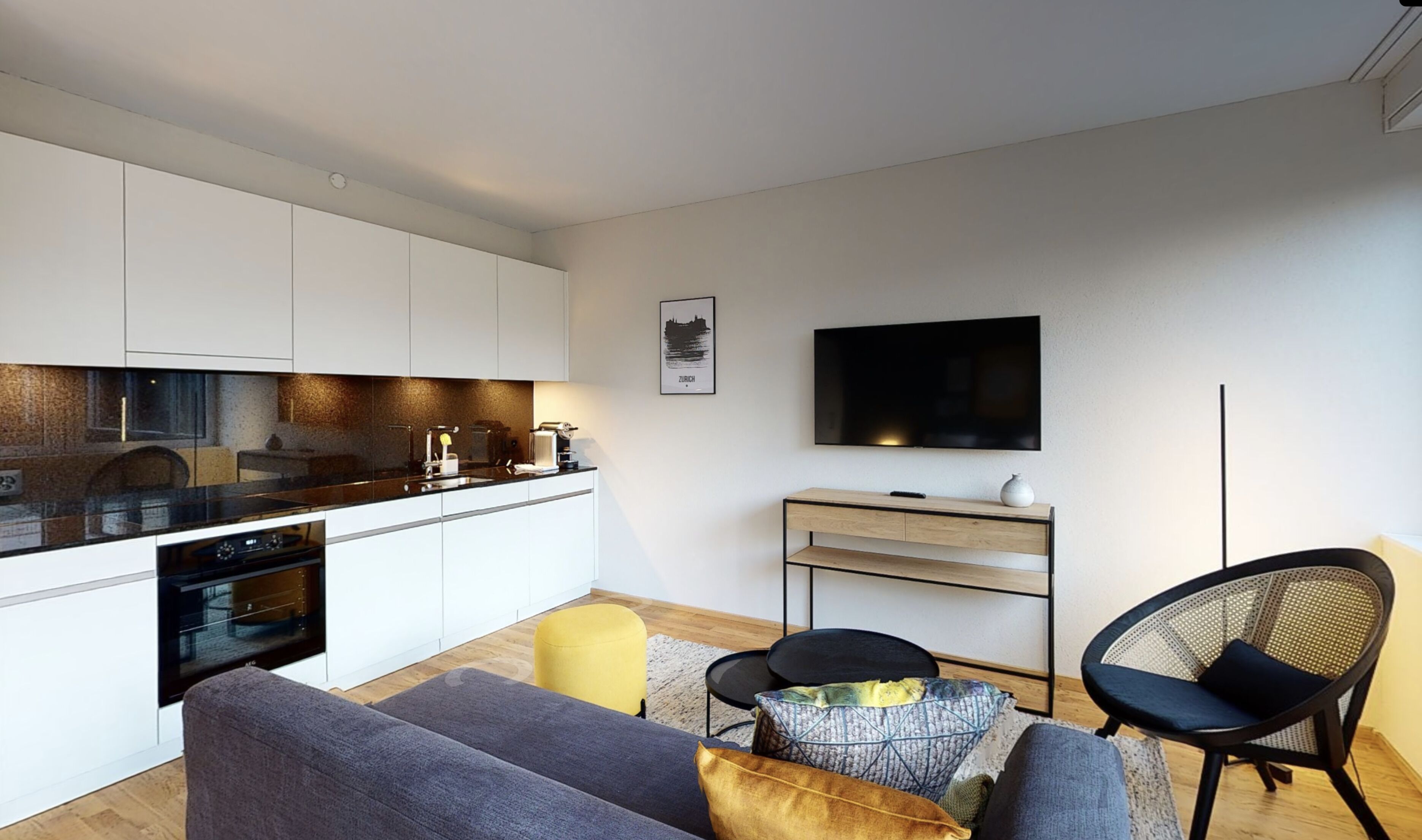 A modern apartment with a kitchen, dining area, and living room.