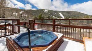 A hot tub on a wooden deck with a view of a snowy mountain and a lake. - Nostalgic Mountain Getaway, Only a Short Walk to Lifts or River Run! (Keystone)