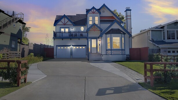 A two-story house with a garage, a balcony, and a chimney. - Talal R Muhtaseb (Oceanside)
