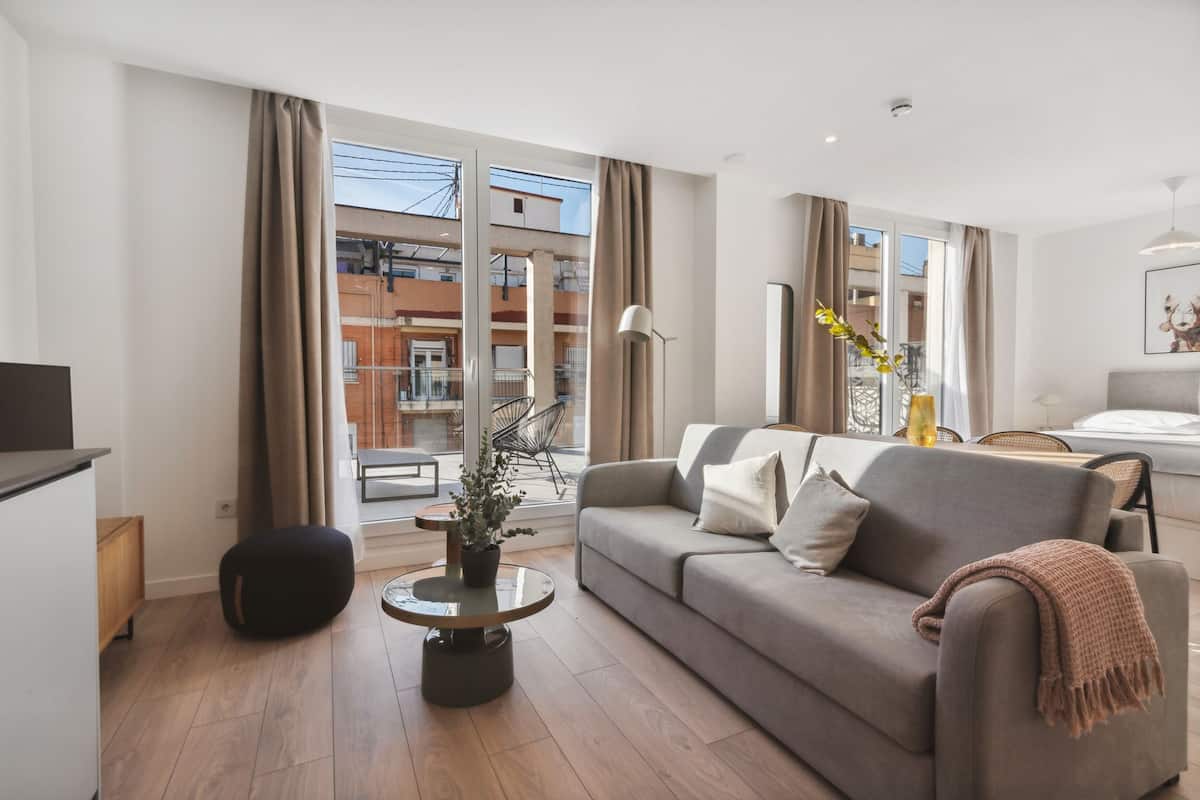 Una sala de estar moderna con un sofá, una mesa de centro y una planta en maceta.