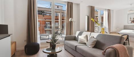 Studio Apartment with sofa bed + terrace | Living area | 50-inch TV with satellite channels