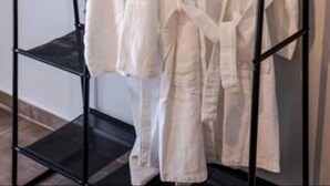 A black metal rack with two white robes hanging on it. - Bijou apartment in Glyfada center (Glyfada)