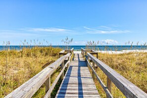A wooden boardwalk leading to a beach with grassy dunes and the ocean in the background. - 🏖️Ocean Overlook-Beautiful 6BR Oceanfront Top 2 Floors of a Duplex🏖️ (Carolina Beach)