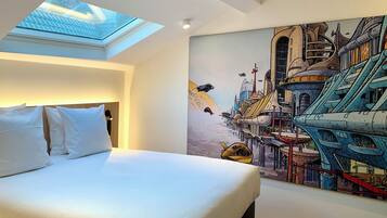 A modern hotel room with a skylight, a large bed with white linens, and a vibrant cityscape mural on the wall.