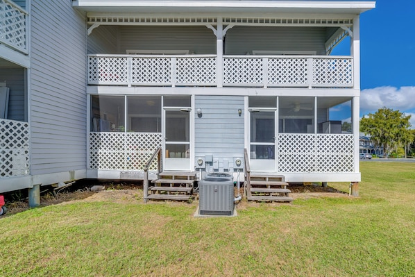 A two-story house with a balcony, a front porch, and an air conditioning unit in the yard. - Community Pool & Boat Ramp! Inverness Home (Inverness)