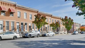 A row of townhouses with a clear street in front.