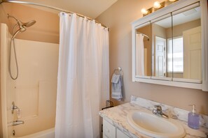 A bathroom with a shower, a sink, a mirror, and a towel rack. - Shiloh Vacation Rental w/ Albemarle Sound Views (Shiloh)