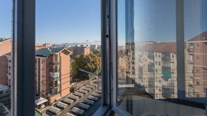 A view from a window overlooking a cityscape with multiple buildings, including residential and commercial structures. - La Casa di Marygrace by Wonderful Italy (Turin)