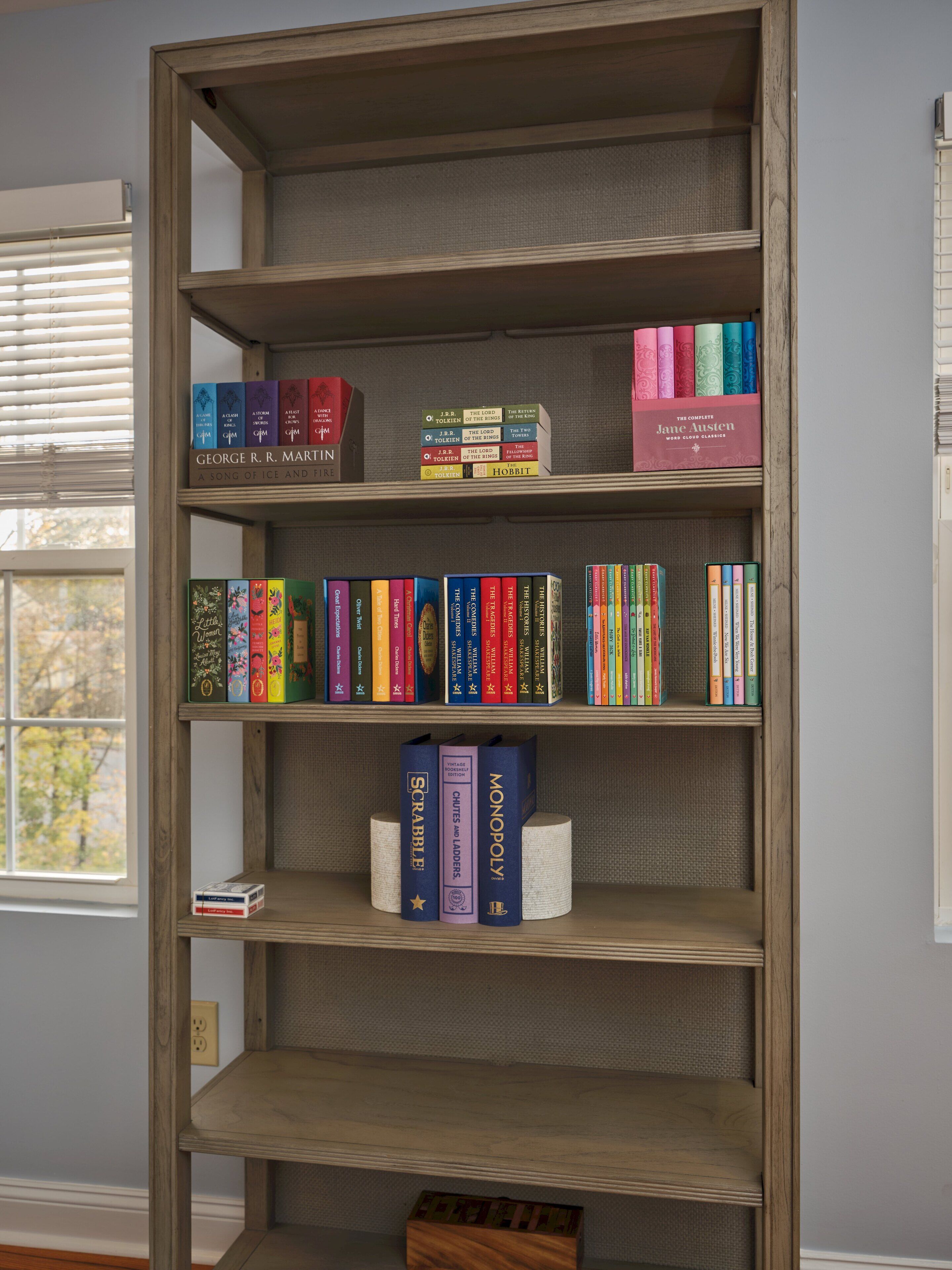 A bookshelf with various books, including 'The Lord of the Rings' series and 'The Complete Jane Austen'.