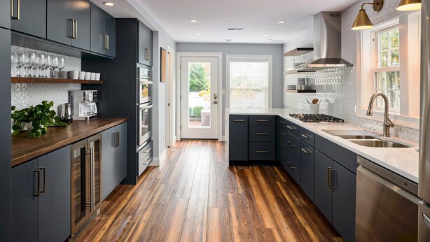 A modern kitchen with dark cabinets, stainless steel appliances, and a wooden floor. - The Lambertville Haven (Lambertville)