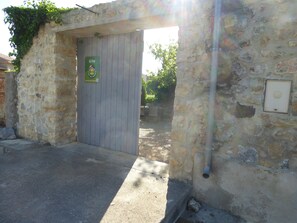 Step into this charming gîte, featuring a traditional stone exterior and a welcoming entrance.