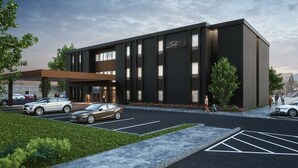 A modern building with a dark facade, large windows, and a sign that reads "Chicory." - The Carpentry Hotel (Dalton)
