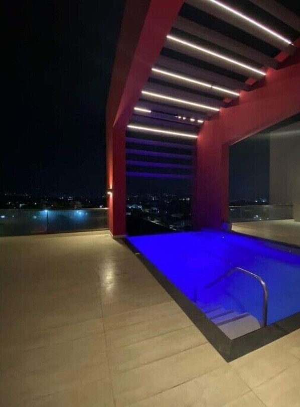 Relax by the pool surrounded by a sleek, modern design.