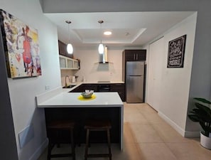 Functional kitchen with central island and modern appliances.