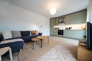 Relax in this stylish living area with a sofa, coffee table, and TV.