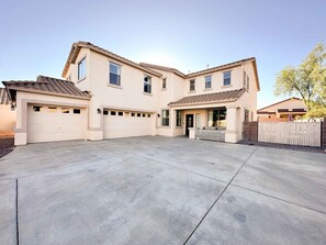 A two-story house with a garage, a covered patio, and a small front yard. - Desert Blooms: Heated Pool & Spa - Winter Oasis (Tucson)