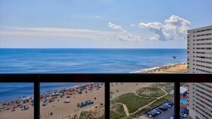 A beach view from a high-rise building with a clear sky and clouds. - Golden Sands 1617 by Seaside Vacations & Sales (Ocean City)