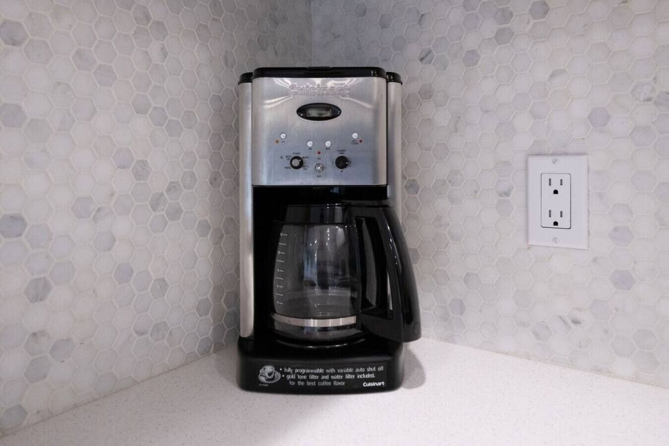 A Cuisinart coffee maker with a programmable interface, a built-in grinder, and a water filter.