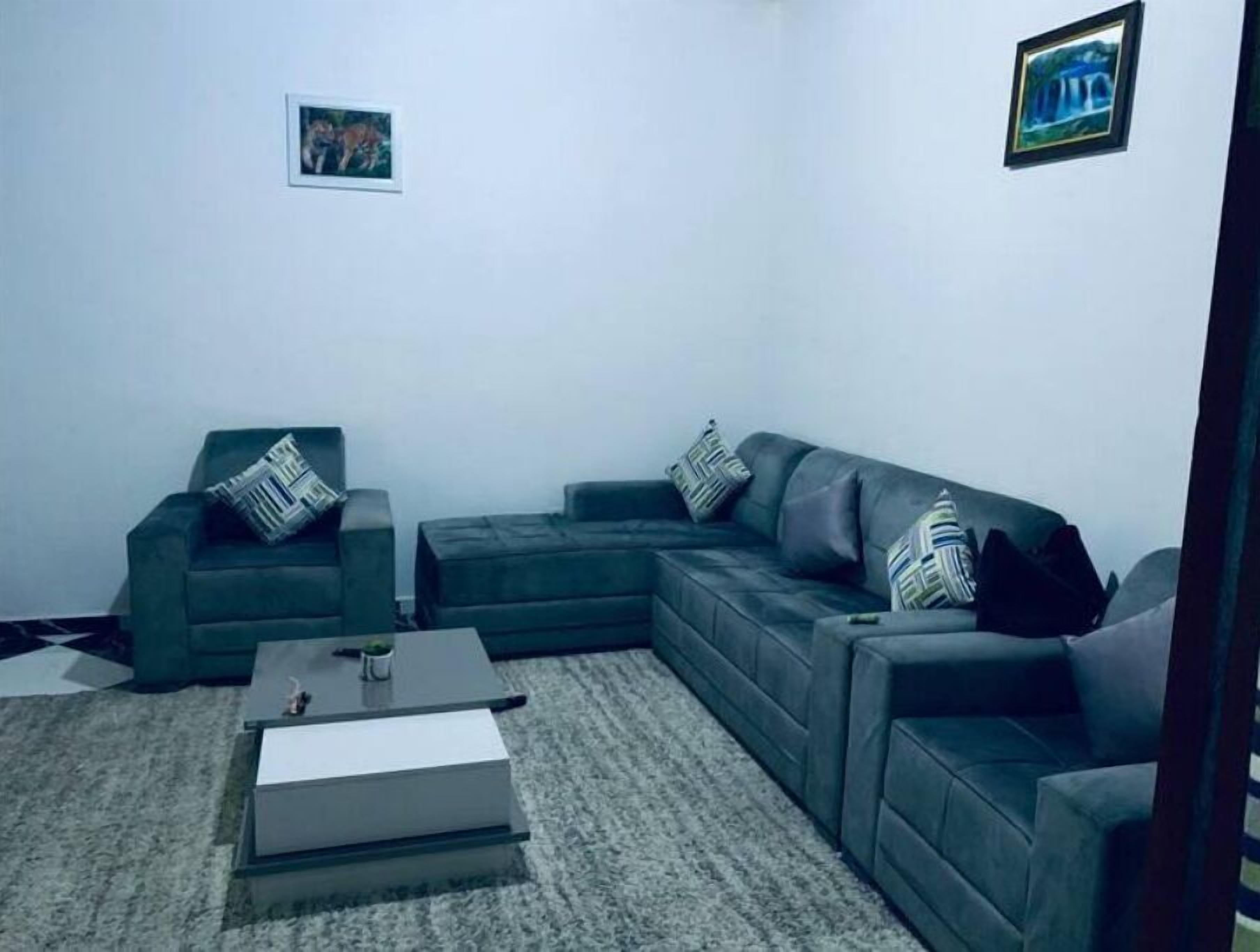 A living room with a sectional sofa, a small coffee table, and a rug.