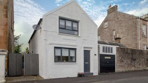 A white two-story house with a garage, a satellite dish, and a 'KEEP CLEAR' sign on the garage door. - Henry Bell 2 bed in Helensburgh Near Loch Lomond (Helensburgh)
