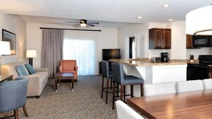 A hotel room with a living area, a dining area, and a kitchenette. - Wyndham Vacation Resort! Serene · Clean · Fun! (Branson)