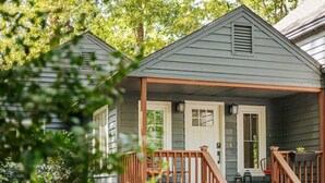 A small, single-story house with a porch and a covered front entrance.
