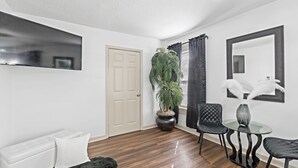 A modern living room with a sofa, a coffee table, and a potted plant.