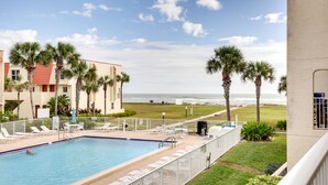 A swimming pool with lounge chairs and a view of the ocean. - St Augustine Poolside Oasis w/ Private Patio! (St. Augustine)