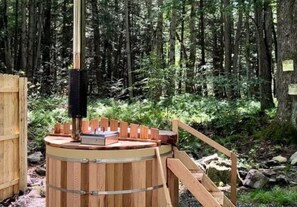 Relax in a secluded hot tub surrounded by the tranquility of the forest.