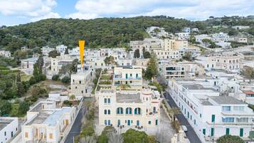 A coastal town with traditional architecture, narrow streets, and a hillside backdrop.